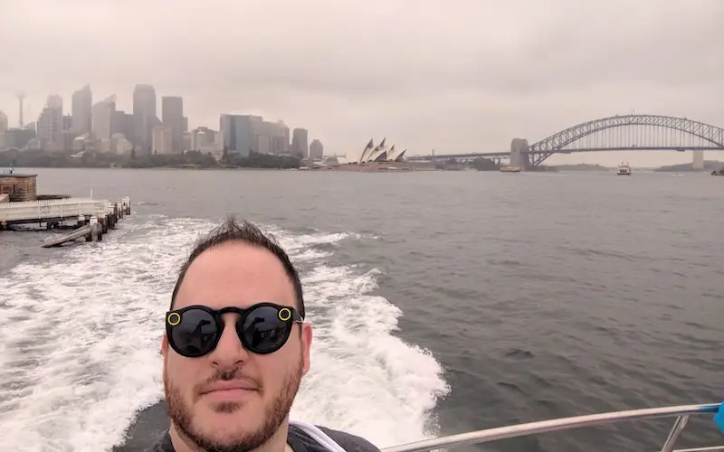 Anshel Sag wears the original Spectacles smart glasses in Sydney Harbor in 2017.